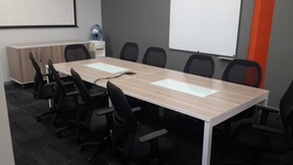 Boardroom table with metal legs and glass inlays